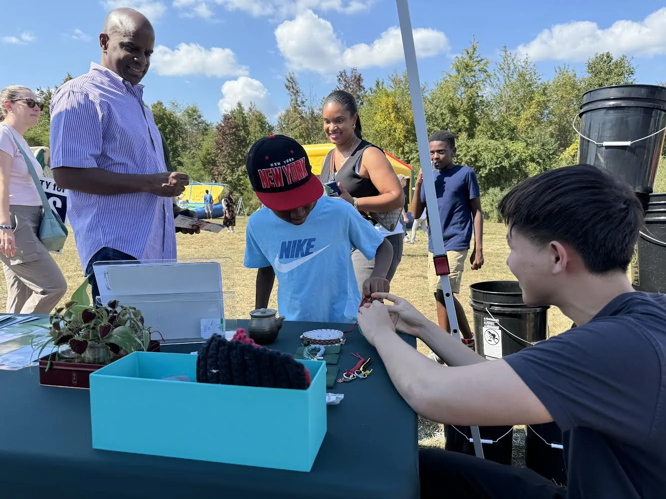 Torus volunteers connecting with families at West Windsor Community Day, next to compost buckets